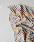 Lifestyle image of Organic Cotton Swaddle in Retro Check