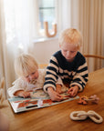 kids at table playing with sticker books