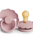 Two FRIGG Daisy Natural Rubber Pacifiers in Baby Pink; one upright to display its latex nipple, the other flat showing the decorative front and handle. This is a Limited Edition 2-Pack by FRIGG.