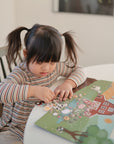 girl playing with sticker farm sticker book