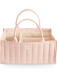 The mushie Diaper Caddy in Blush is a soft, quilted organizer with sturdy handles and multiple interior compartments, shown on a white background.