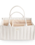 The mushie Diaper Caddy in Ivory features a quilted design, two handles, and multiple beige interior compartments, shown against a white background.