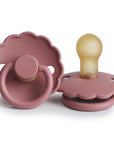 Two FRIGG Daisy Natural Rubber Pacifiers in Dusty Rose are shown—one flat, one upright—both with scalloped edges and beige latex nipples. This is the Limited Edition 2-Pack from FRIGG.