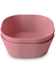 Two pink Square Dinnerware Bowls by mushie are stacked on a white background. Made from BPA-free plastic, this set is ideal for mealtime with your little one.