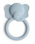 The mushie Elephant Teether is a light blue, soft silicone teether shaped like an elephant's head with big ears and a trunk that forms a circular handle—ideal for soothing your baby.