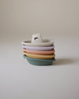 Mushie Bath Boats: stackable, pastel-colored, non-toxic plastic boats with handles.