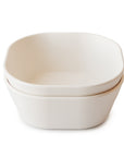 Two white, square-shaped mushie Square Dinnerware Bowls are stacked together and viewed from a slightly elevated angle against a plain white background.