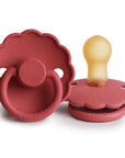 Two FRIGG Daisy Natural Rubber Pacifiers in Scarlet—one flat, one upright—feature scalloped edges, round handles, and beige natural rubber nipples. Limited edition 2-pack.
