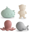 The mushie Sealife Mold Free Bath Play Set includes four silicone toys—a mint green submarine, cream diver bear, pink octopus, and gray whale—with modern designs for safe, mold-free bath fun. Shown on a white background.