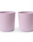 Two mushie Dinnerware Cups, light pink and non-toxic with a smooth matte finish, are placed side by side on a white background. Their simple modern design makes them ideal as safe and stylish kids cups.