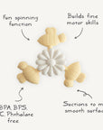 The mushie Suction Spinner Toy features a flower shape with three yellow turtles, made of food-grade silicone. It suctions to most smooth surfaces, spins for fun, and helps build fine motor skills.