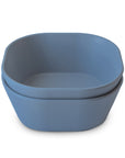 Two stacked, square-shaped mushie Square Dinnerware Bowls in blue, crafted from smooth BPA-free material, are shown on a white background.