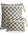 Two rectangular mushie Water Resistant Wet Bags in Olive Check with zipper closures and beige fabric side straps are shown overlapping on a white background.