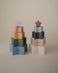 Two mushie Nesting Stars Toys sit side by side on a plain background.