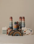 A mushie Phone Press Toy, designed for sensory play, is displayed neatly against a plain beige background.