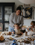 Woman and kids enjoy snacks and donuts, playing with mushie Kaleidoscopes for fun exploration.