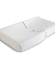 A white, contoured changing pad with safety straps for diaper changes. Pair it with the mushie Extra Soft Muslin Changing Pad Cover for added comfort and style.