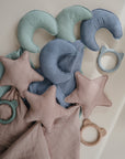 The mushie Star Lovey Blanket is an organic cotton muslin baby blanket, perfect for pairing with soft star cushions and teething rings in mint, blue, and blush pink.