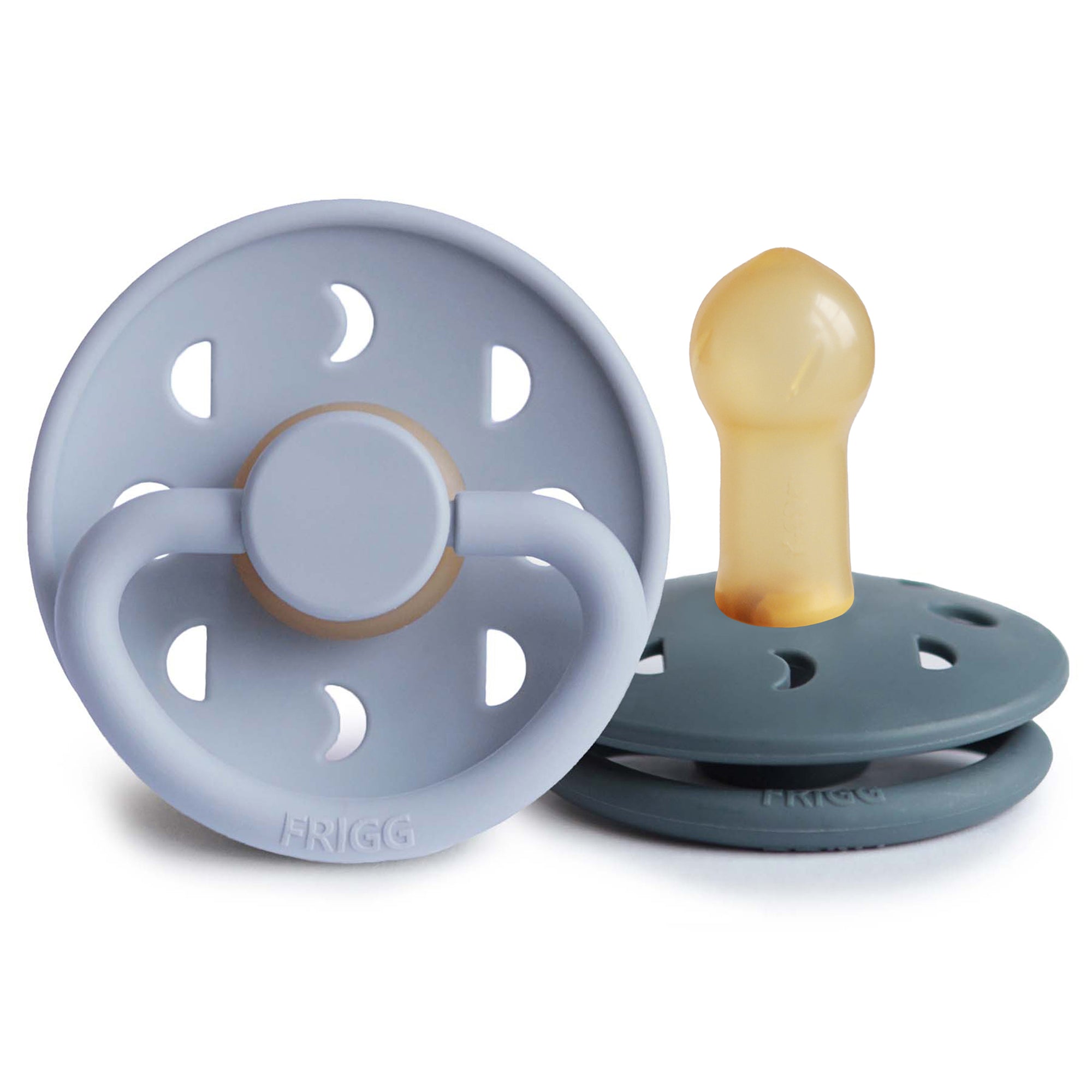 Two Frigg Moon Rubber baby pacifiers, one Powder Blue and one Slate, on a white background.