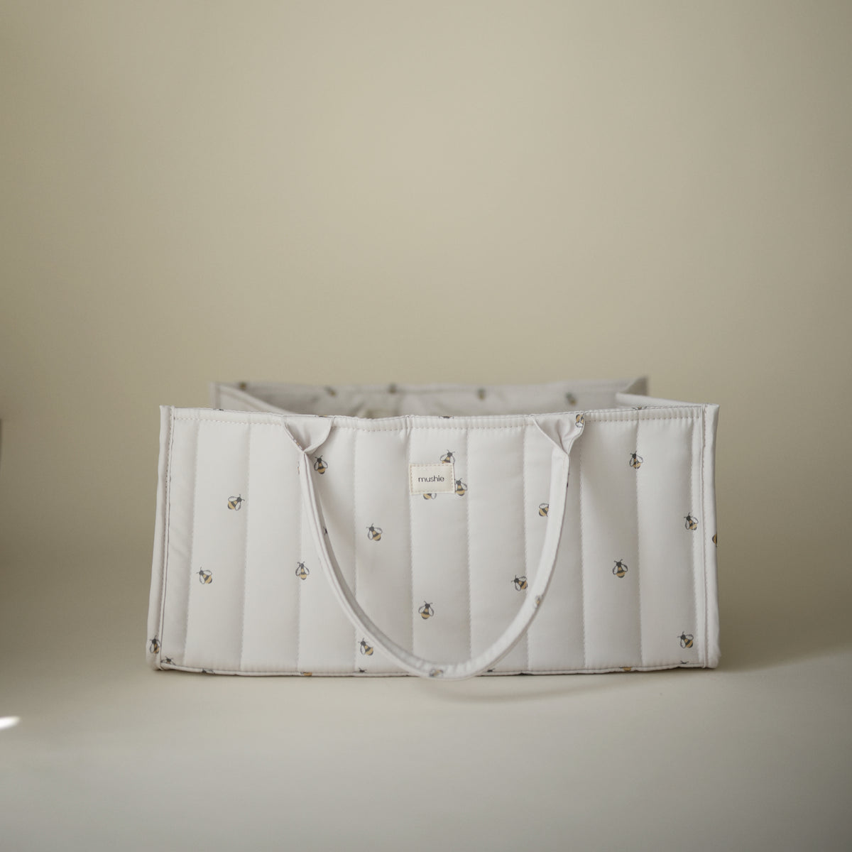 Mushie Diaper Caddy: white, quilted with small embroidery, displayed on a neutral background.