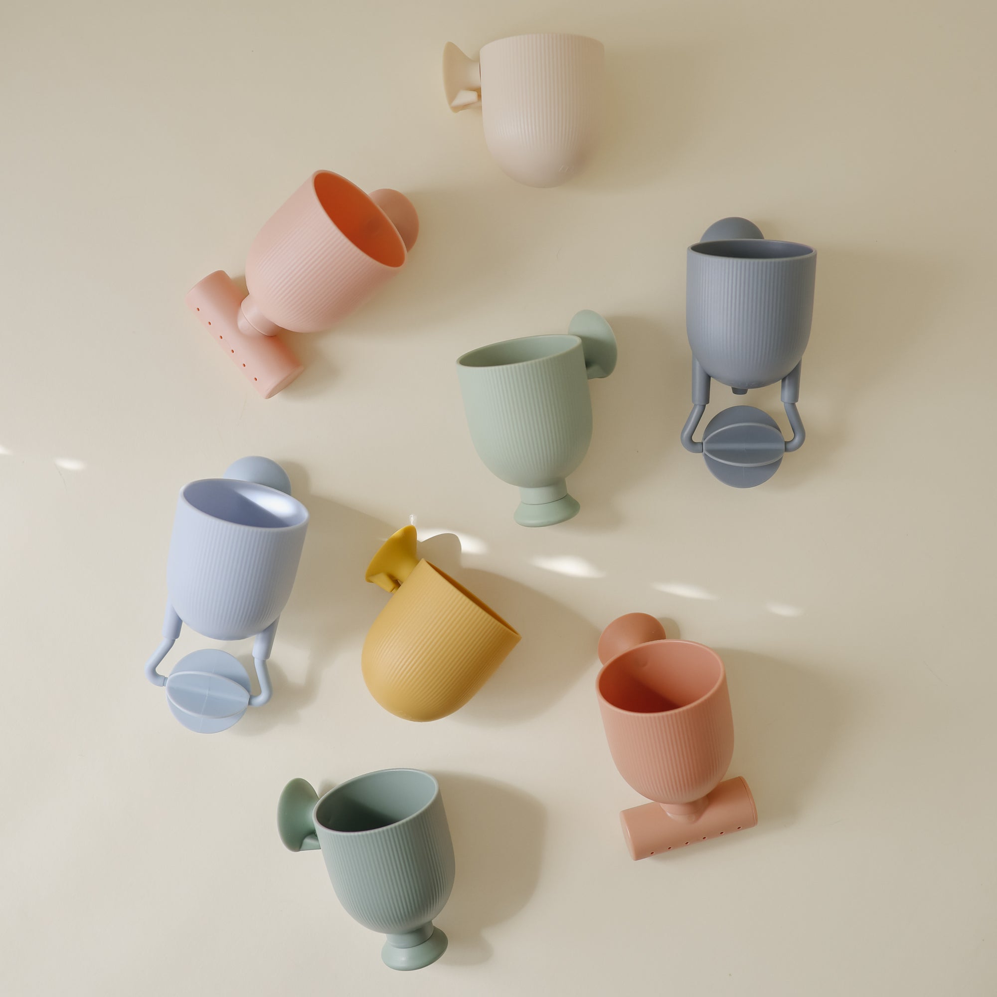 Mushie Pour and Play Bath Set: 7 colorful, ribbed cups for sensory fun in the bath.
