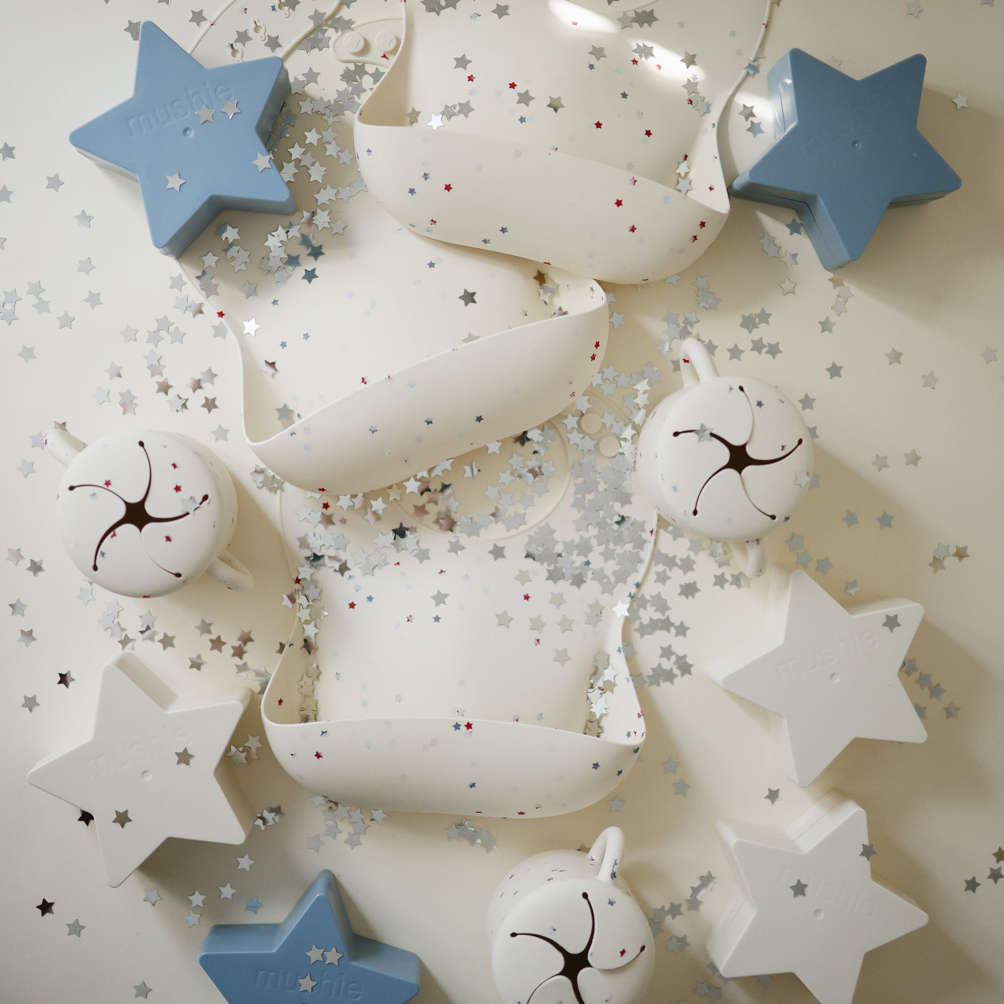 Mushie Snack Cup: white &amp; blue star-shaped, spill-proof silicone cup for toddlers.