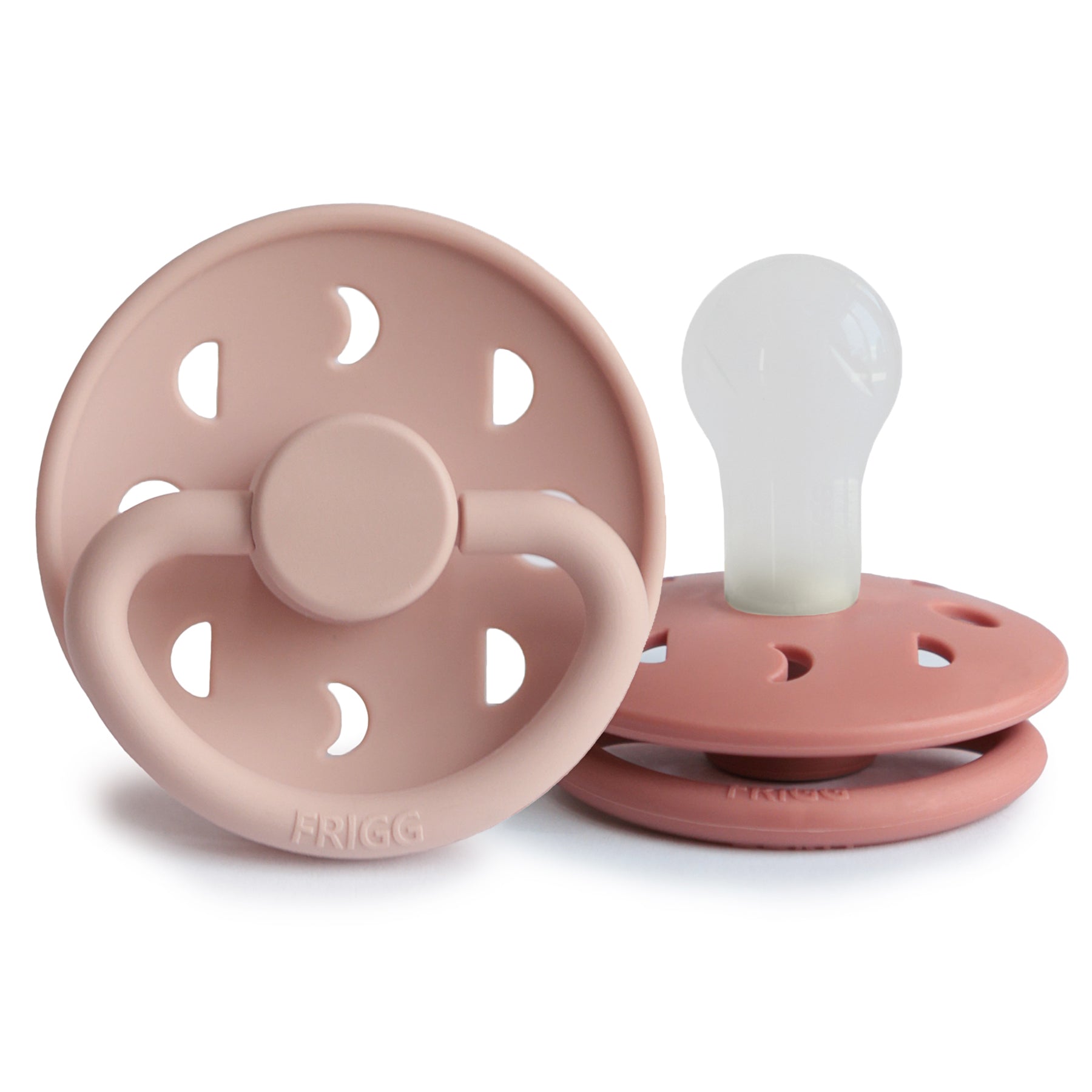 Two FRIGG Moon Silicone Pacifiers—pink 2-pack, baby essentials; one upright, one flat.