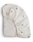 Mushie Extra Soft Bassinet Muslin Crib Sheet, brown and gray print, folded on white background.
