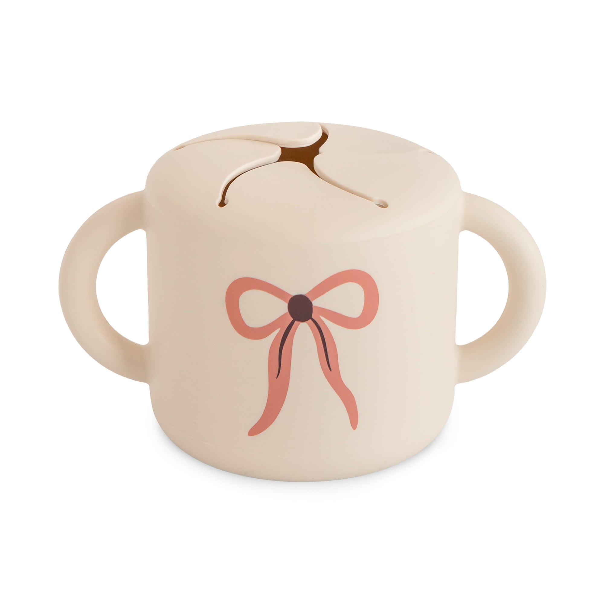 Mushie Snack Cup: Beige, spill-proof, two handles, pink bow design on front.