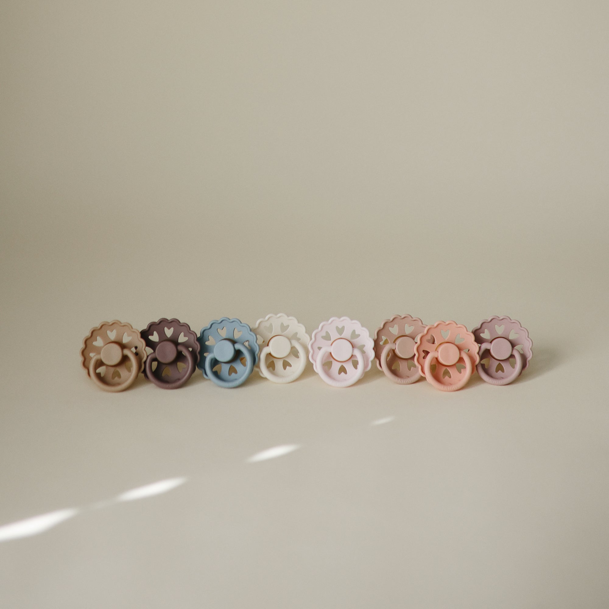 Two FRIGG Andersen Fairytale Silicone Pacifiers rest side by side on a neutral background.