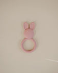 The mushie Bunny Teether is a pink silicone, non-toxic teether for soothing little gums.