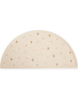 Mushie Silicone Placemat: Beige, semicircle, food-grade with small rainbow and sun patterns.