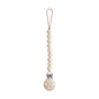 The mushie Silicone Pacifier Clip | Hera features round, food-grade silicone beads in beige and a secure circular metal clasp, providing a minimalist way to attach your baby's pacifier to their clothing.