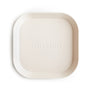 The mushie Square Dinnerware Plate is an off-white, BPA-free plastic baby plate with a minimalist design, rounded corners, raised edges, and "mushie" embossed in the center.
