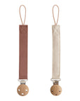 Mushie Linen Pacifier Clip 2-Pack: brown & beige with wood clips for secure pacifier holding.