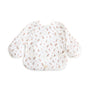 Mushie Long Sleeve Bib in a pink floral print with a front crumb pocket.