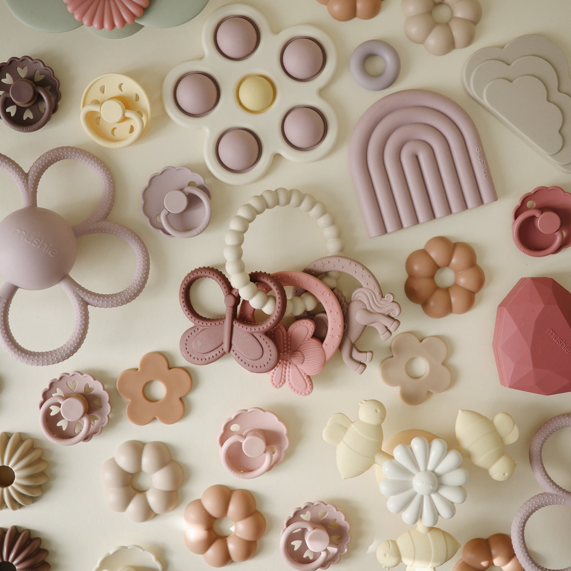 Mushie Fairy Teething Ring: pastel food-grade silicone baby toy for sensory exploration.