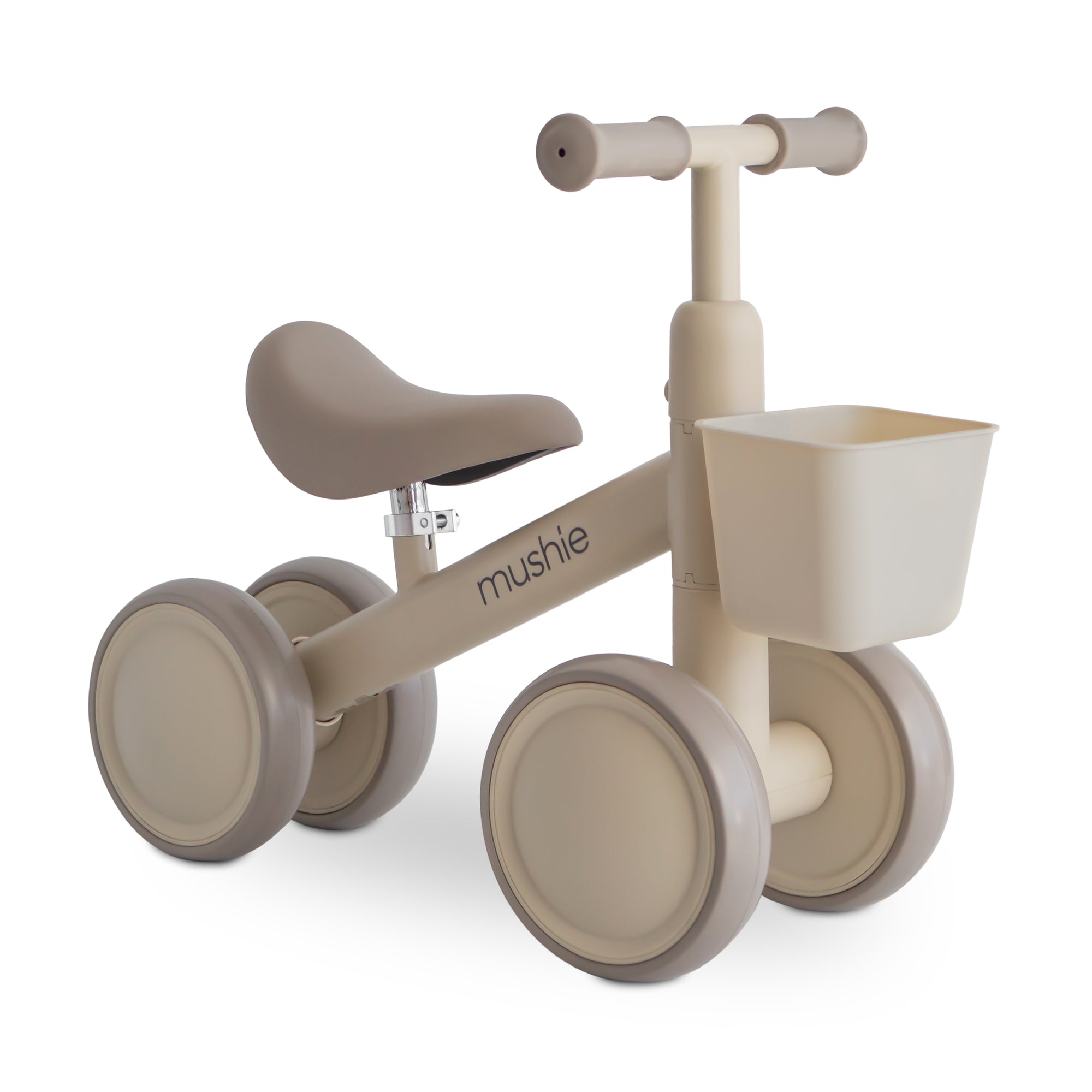 Mushie Mini Toddler Bike in Shifting Sand with front basket and cushioned seat for toddlers.