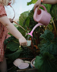 Two kids use mushie's Mix and Match Toy, building fine motor skills while playing outside.