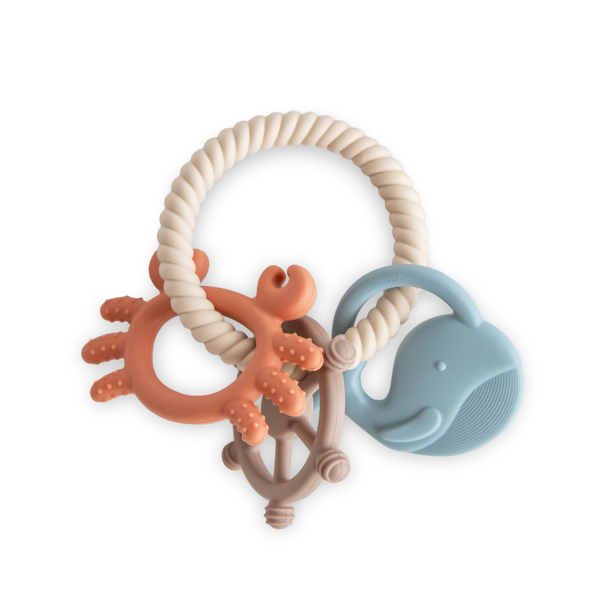 Mushie Teething Ring with crab, steering wheel, and blue whale for soothing sensory relief.