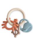 Mushie Teething Ring with crab, steering wheel, and blue whale for soothing sensory relief.