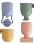 The mushie Pour and Play Bath Set features four textured, colorful cups for sensory play.