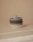 Mushie Bath Boats in neutral colors, perfect water play toys on a beige background.