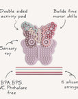 Mushie Silicone Sensory Toy: butterfly-shaped with textured surface and strings for fine motor play.