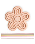 The mushie Silicone Sensory Toy is a peach flower mat with pastel straws for fine motor play.