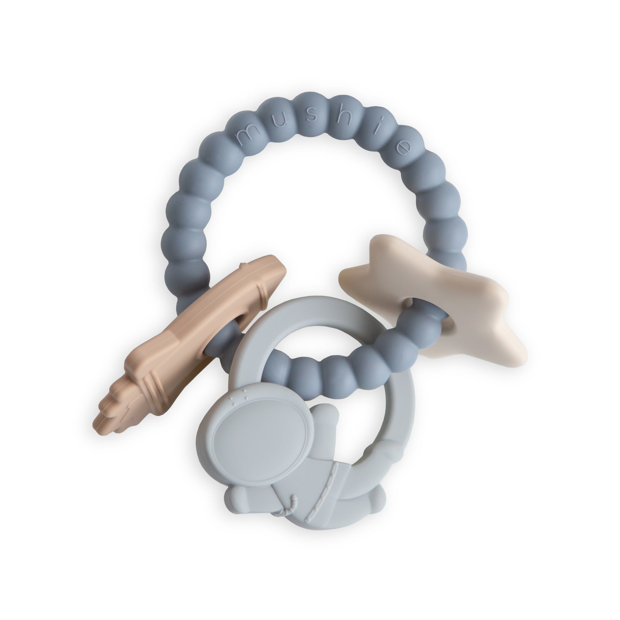 A silicone baby teething toy with beaded blue ring and attached shapes, including a beige rocket, a white star, and a gray astronaut, all linked together on a white background.