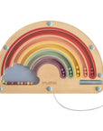 The Wooden Magnetic Rainbow Maze by mushie features colorful beads that slide along curved tracks, encouraging fine motor skills and screen-free play. Includes a gray cloud on the left, string at bottom right, and "mushie" printed near the center.