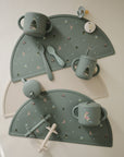 Christmas Bunny Feeding Kit containing holiday-themed silicone cups, spoons, and placemats.