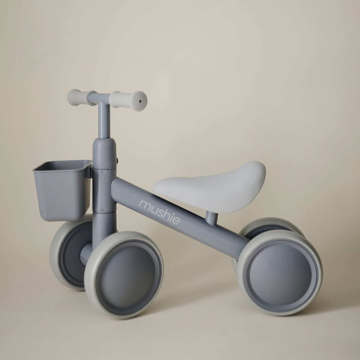Grey mushie Mini Toddler Bike with a small front basket.