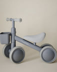 Grey mushie Mini Toddler Bike with a small front basket.
